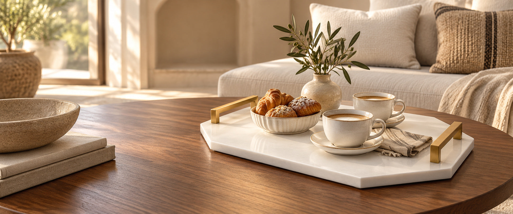 Pure White stone tray with gold handles, coffee and pastries in a sunlit living room.