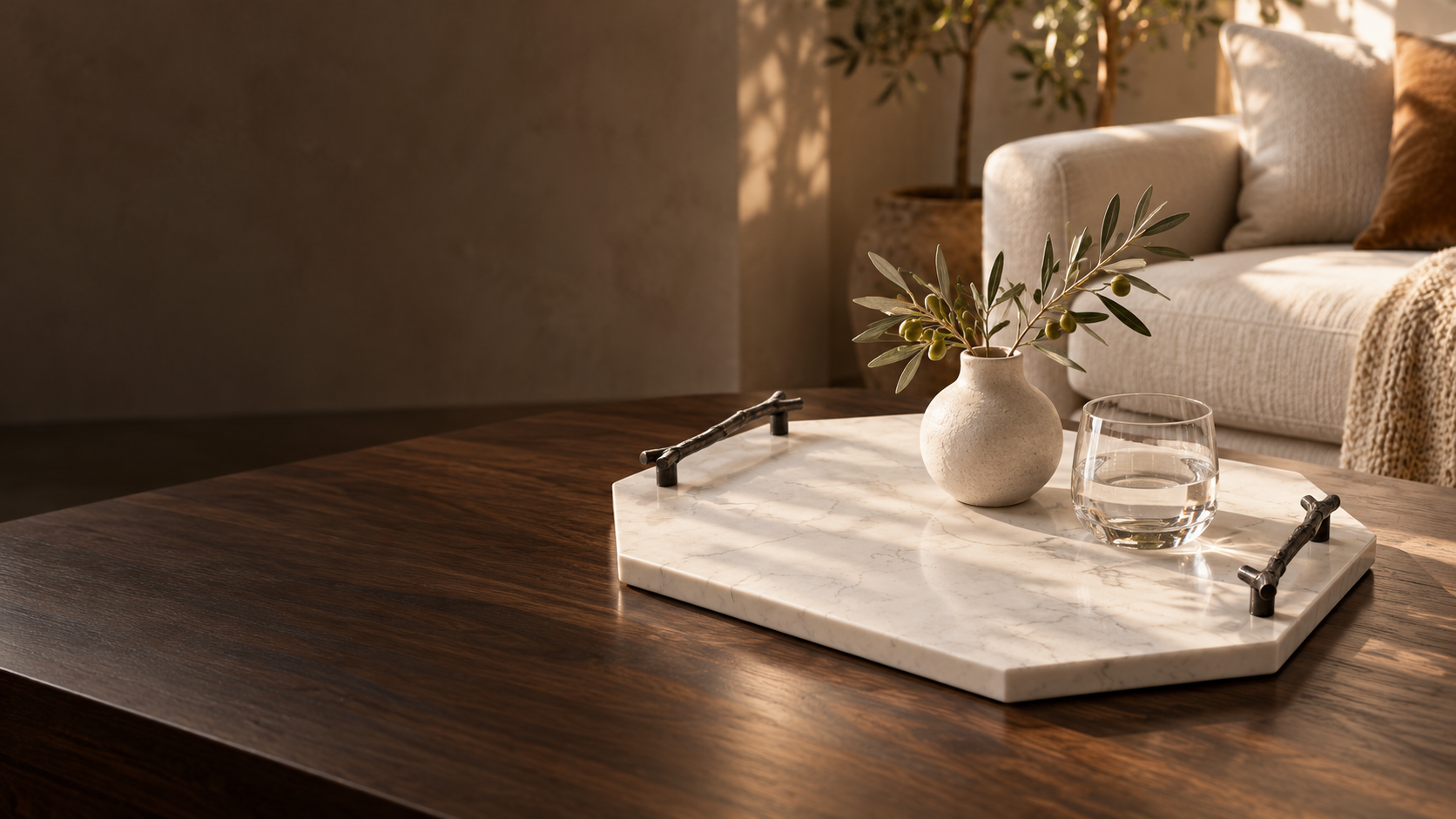 Carrara stone tray with dark branch handles on a walnut coffee table