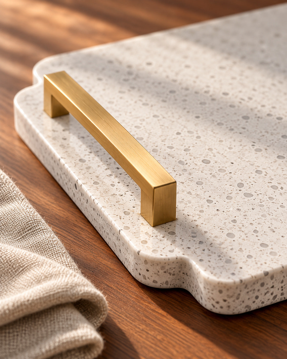 Close detail of a stone tray and gold handle.